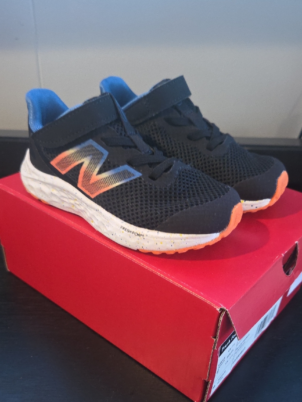 New Balance Kids Black Sneakers with Orange & Blue Accents